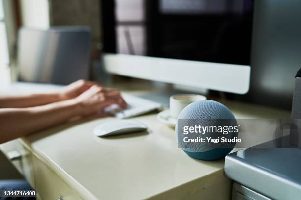 working from home and using a smart speaker - voice search stock pictures, royalty-free photos & images