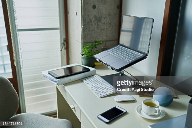 working from home and using a smart speaker - desk tablet phone monitor stock pictures, royalty-free photos & images