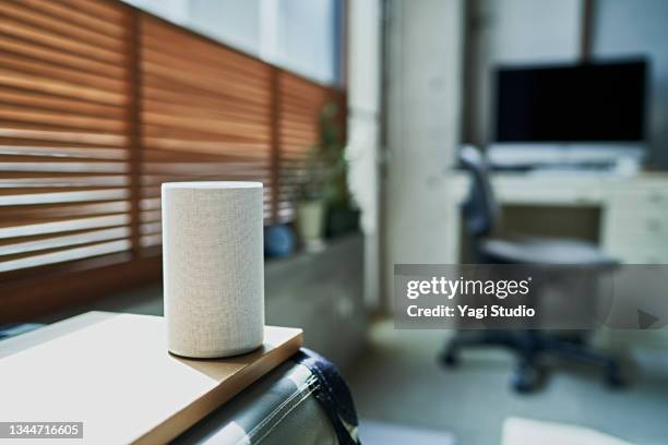 smart speakers in the living room - smart speaker stock pictures, royalty-free photos & images