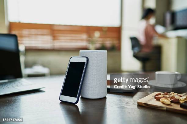 working from home and using a smart speaker - prop stock pictures, royalty-free photos & images