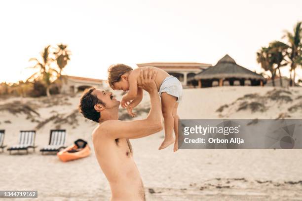 father and son at the beach in  mexico - acapulco shore bildbanksfoton och bilder
