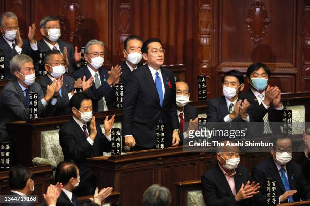 Ruling Liberal Democratic Party president Fumio Kishida is applauded by lawmakers as he is elected as Japan's new prime minister at the House of...