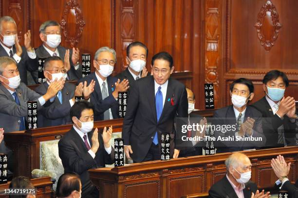 Ruling Liberal Democratic Party president Fumio Kishida is applauded by lawmakers as he is elected as Japan's new prime minister at the House of...