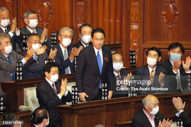 Ruling Liberal Democratic Party president Fumio Kishida is applauded by lawmakers as he is elected as Japan's new prime minister at the House of...