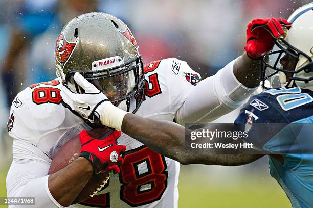 Kregg Lumpkin of the Tampa Bay Buccaneers stiff arms Jason McCourty of the Tennessee Titans at LP Field on November 27, 2011 in Nashville, Tennessee....