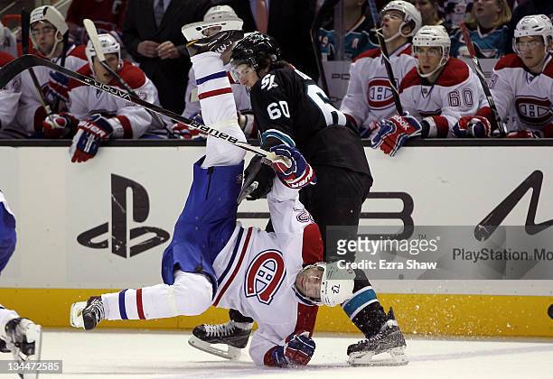 Erik Cole of the Montreal Canadiens is hit by Jason Demers of the San Jose Sharks in the third period at HP Pavilion at San Jose on December 1, 2011...