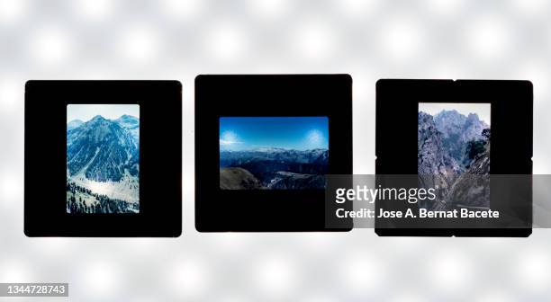 close-up of photographic slides on a white background. - diastreifen stock-fotos und bilder