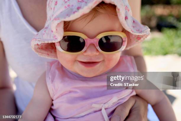 mother and baby in sunshine - baby sunglasses stock pictures, royalty-free photos & images