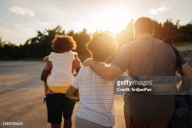 harmonious multiracial stepfamily ready for the sports activity as their weekend tradition - blended family stockfoto's en -beelden