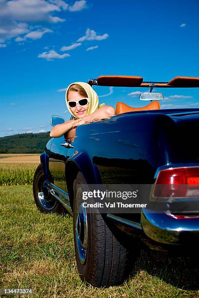 young woman sitting in a mercedes mb w113 230sl, produced from 1963-1967 - 1963 stock pictures, royalty-free photos & images