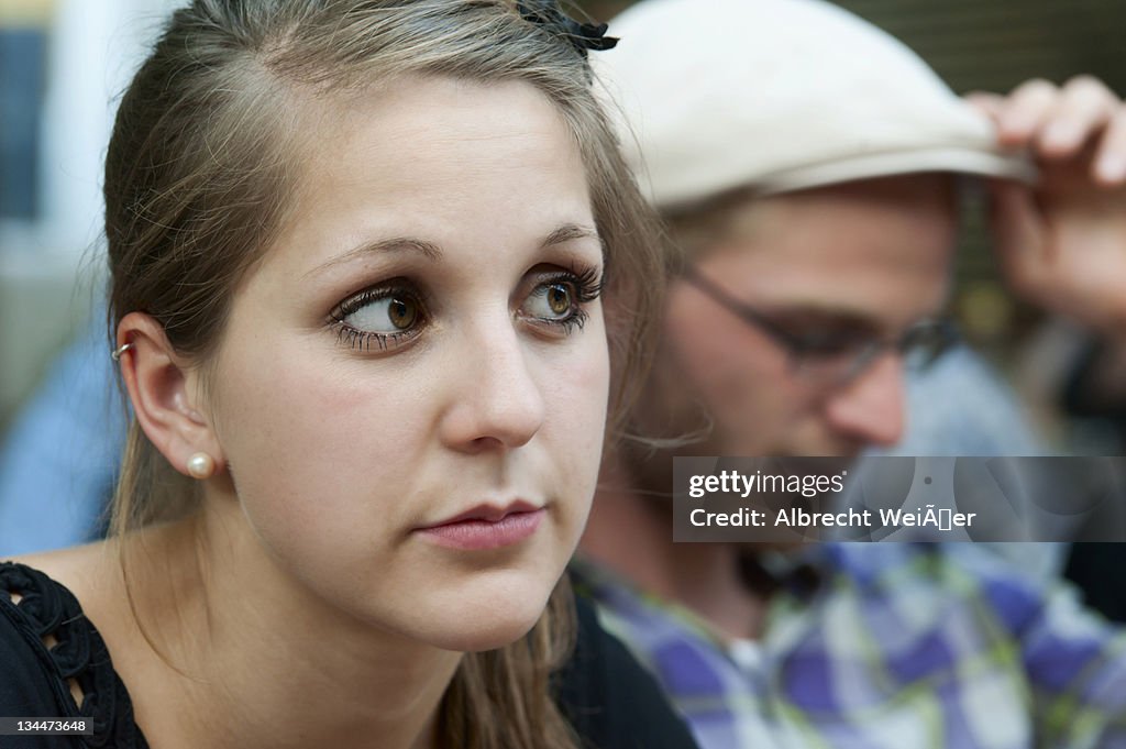 A young man and a young woman looking a bit bored, Germany, Europe