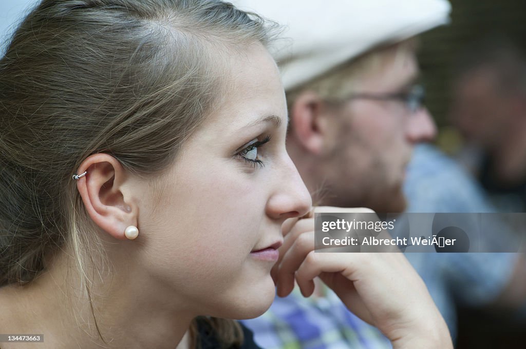 A young man and a young woman looking a bit bored, Germany, Europe