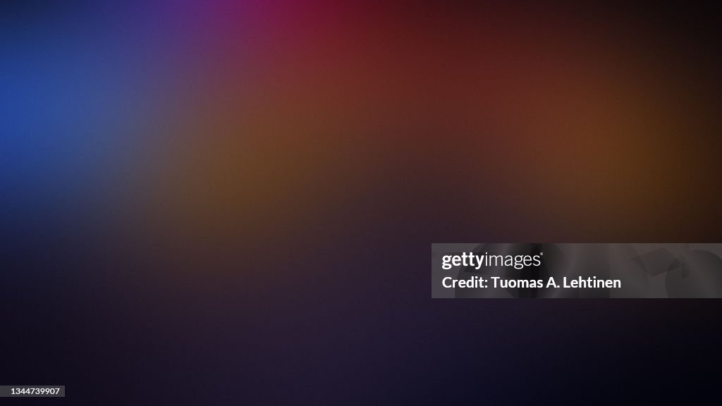 Soft and blurred colorful grainy textured gradient background.