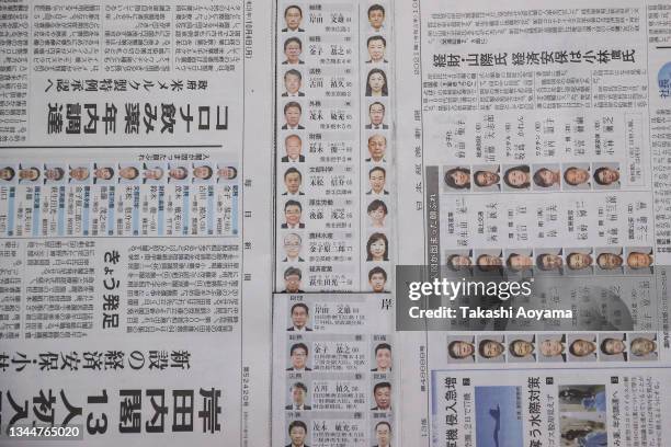 In this photo illustration, reaction to the new prime minister Fumio Kishida and his cabinet is seen on the front pages of Japanese newspapers on...