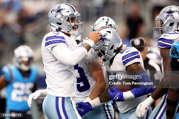 Dak Prescott of the Dallas Cowboys celebrates with Ezekiel Elliott after running for a touchdown during the first quarter against the Carolina...