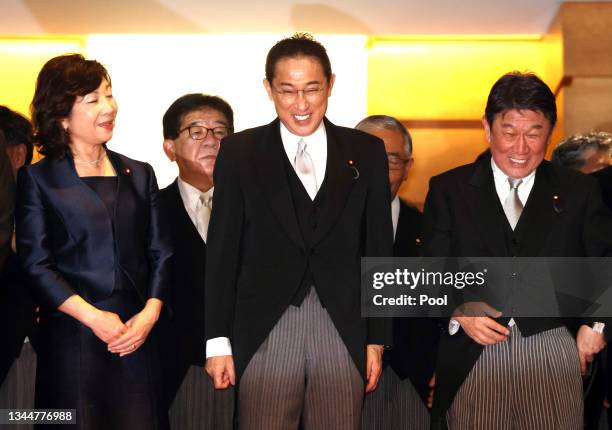 Newly elected Prime Minister Fumio Kishida shares smiles with Foreign Minister Toshimitsu Motegi and Gender Equality Minister Seiko Noda prior to...