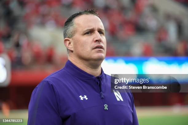 Head coach Pat Fitzgerald of the Northwestern Wildcats watches the team warm up before the game against the Nebraska Cornhuskers at Memorial Stadium...