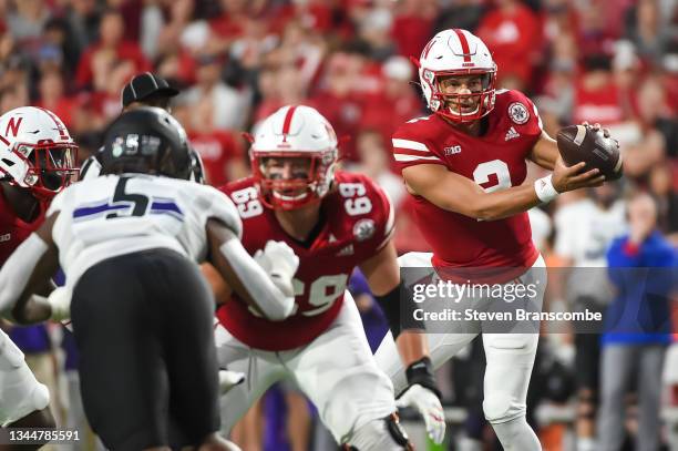 Quarterback Adrian Martinez of the Nebraska Cornhuskers takes a snap against the Northwestern Wildcats in the first half at Memorial Stadium on...