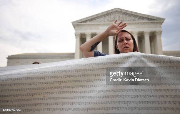 An anti-abortion activist holds a petition to end abortion during a demonstration outside of the Supreme Court on October 04, 2021 in Washington, DC....