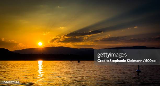 scenic view of lake against sky during sunset,kelowna,british columbia,canada - kelowna stock pictures, royalty-free photos & images