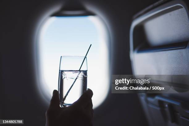 cropped hand holding drink in glass - rubbing alcohol stock pictures, royalty-free photos & images