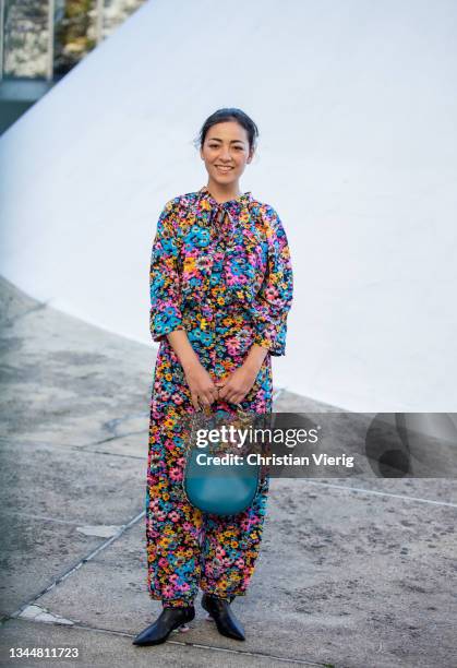 Guest is seen wearing blouse and pants with floral print, bag outside Stella McCartney during Paris Fashion Week - Womenswear Spring Summer 2022 on...