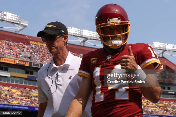 Washington Football Team head athletic trainer Ryan Vermillion helps quarterback Ryan Fitzpatrick of the Washington Football Team off of the field...