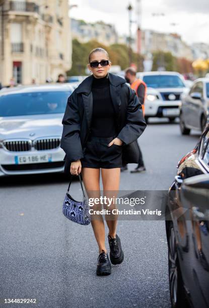 Caroline Daur seen wearing black shorts, turtleneck, down feather jacket, Prada bag, sunglasses outside Giambattista Valli during Paris Fashion Week...