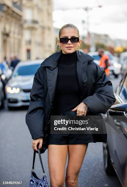 Caroline Daur seen wearing black shorts, turtleneck, down feather jacket, Prada bag, sunglasses outside Giambattista Valli during Paris Fashion Week...