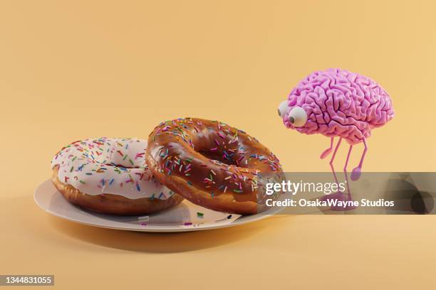 pink human brain looking forward to plate with doughnuts - sugar food 個照片及圖片檔