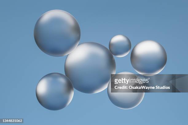 silver opaque material bubbles against blue grey background - particle sphere stock pictures, royalty-free photos & images