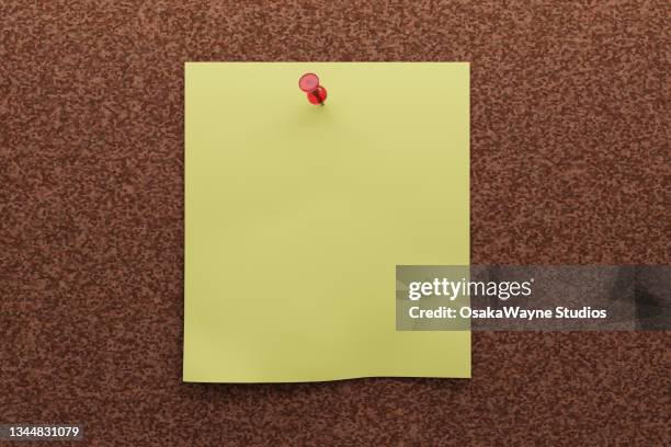 blank yellow note paper pinned on cork board - list graphics stock pictures, royalty-free photos & images