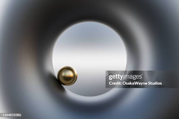small glossy sphere rotating inside matt metallic geometric object - movimiento perpetuo fotografías e imágenes de stock