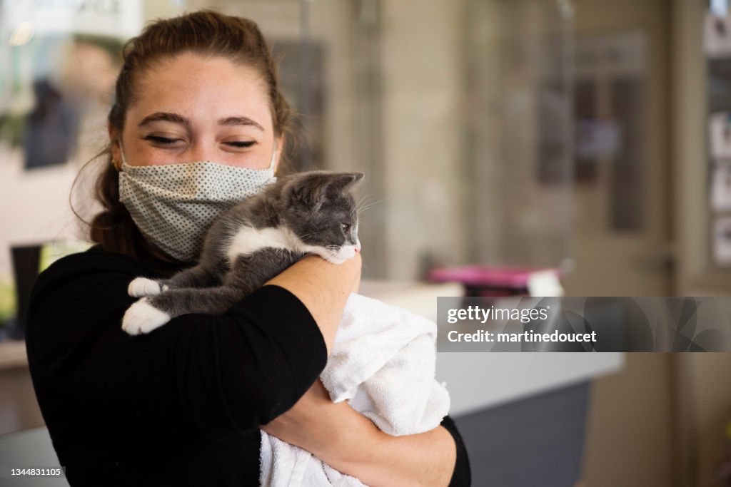 First meeting of newly adopted kitten and young woman.