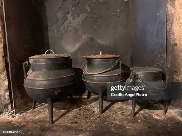 three pots in an old kitchen - ollas de barro fotografías e imágenes de stock