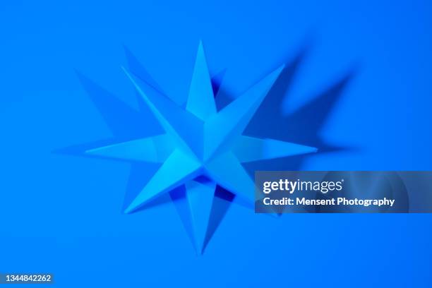 origami geometric paper folded shape in neon light - star decoration stock pictures, royalty-free photos & images