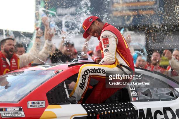 Bubba Wallace, driver of the McDonald's Toyota, celebrates in the Ruoff Mortgage victory lane after winning the rain-shortened NASCAR Cup Series...