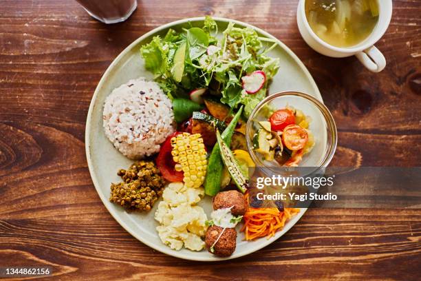 vegan plate lunch with organic vegetables - luncheon stock-fotos und bilder