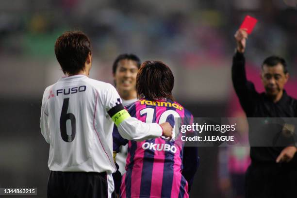 Yoshito Okubo of Cerezo Osaka is shown a red card by referee Keiichi Sunagawa during the J.League J1 second stage match between Cerezo Osaka and...