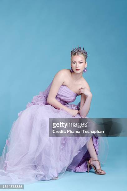 beautiful woman wearing evening gown and tiara - purple dress stockfoto's en -beelden