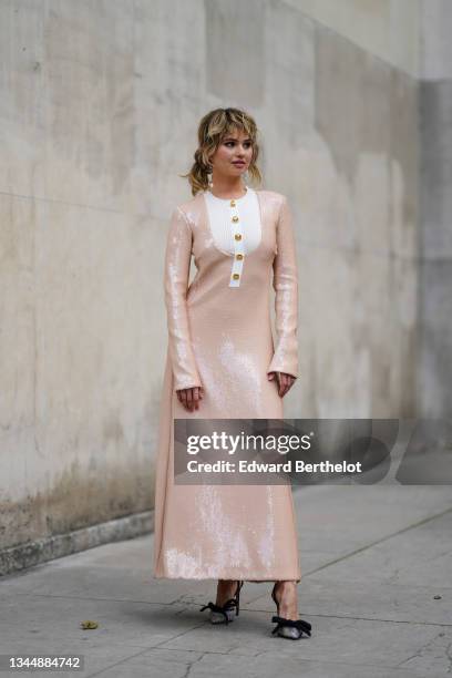 Debby Ryan wears a white ribbed with gold buttons neck on a pale pink V-neck shiny sequined long sleeves / long dress, rings, silver rhinestoned...