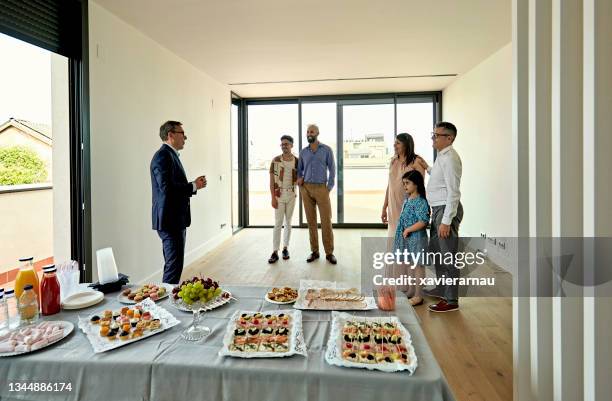 real estate agent and prospective buyers at open house - open house stock pictures, royalty-free photos & images