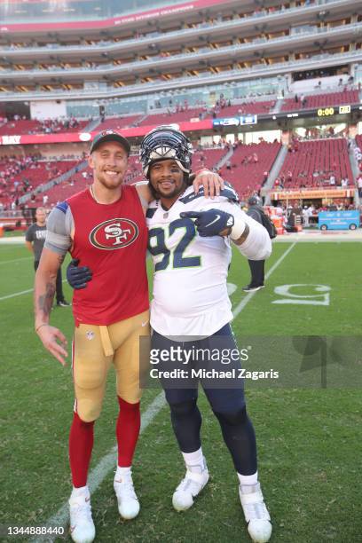 George Kittle of the San Francisco 49ers and Robert Nkemdiche of the Seattle Seahawks on the field after the game at Levi's Stadium on October 3,...