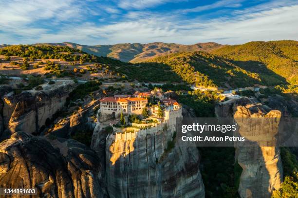 mountain monastery meteora at sunset, greece. - monastery stock pictures, royalty-free photos & images