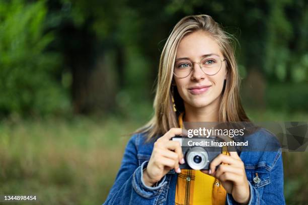 teenage girl photographing with a vintage camera - girl camera bildbanksfoton och bilder