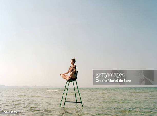 young woman meditating in sea - wit stock pictures, royalty-free photos & images