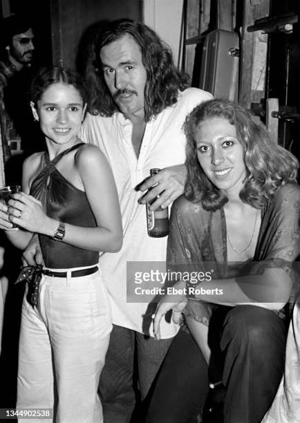 American country musician Commander Cody with his backup singers, Nicolette Larson and Charra Penny, backstage at The Bottom Line in New York City on...