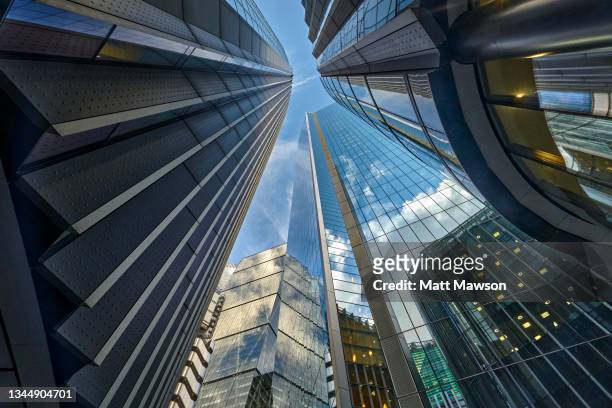 low angle view looking down lime street to lloyds of london building, the scalpel building, willis building and the leadenhall building in the city of london uk - london business stock-fotos und bilder