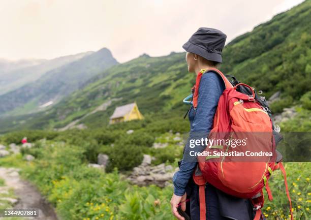 hikingwoman in the mountains with a backpackin  national park rodna, romania, europe - maramureș stock pictures, royalty-free photos & images