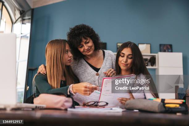 mother helping her daughter to study on a research and homework - college preparation stock pictures, royalty-free photos & images